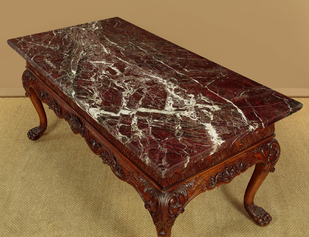 A George II style side table featuring a carved wooden frame with cabriole legs, ball and claw feet, and a polished dark marble top. View IV