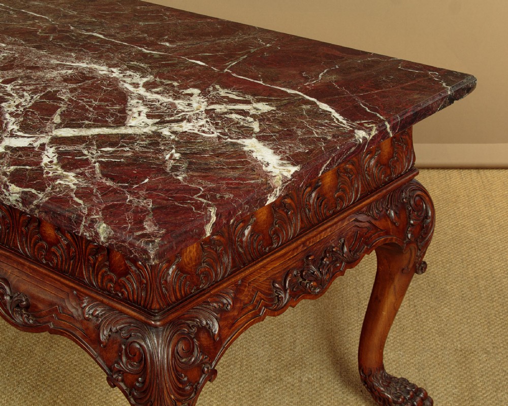 A George II style side table featuring a carved wooden frame with cabriole legs, ball and claw feet, and a polished dark marble top. View V