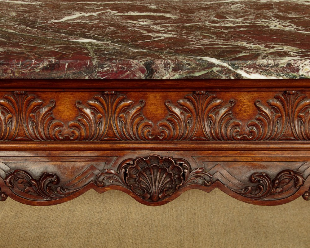 A George II style side table featuring a carved wooden frame with cabriole legs, ball and claw feet, and a polished dark marble top. View VII