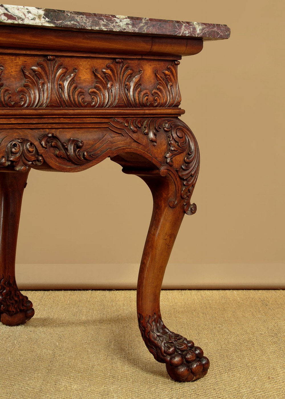 A George II style side table featuring a carved wooden frame with cabriole legs, ball and claw feet, and a polished dark marble top. View VIII
