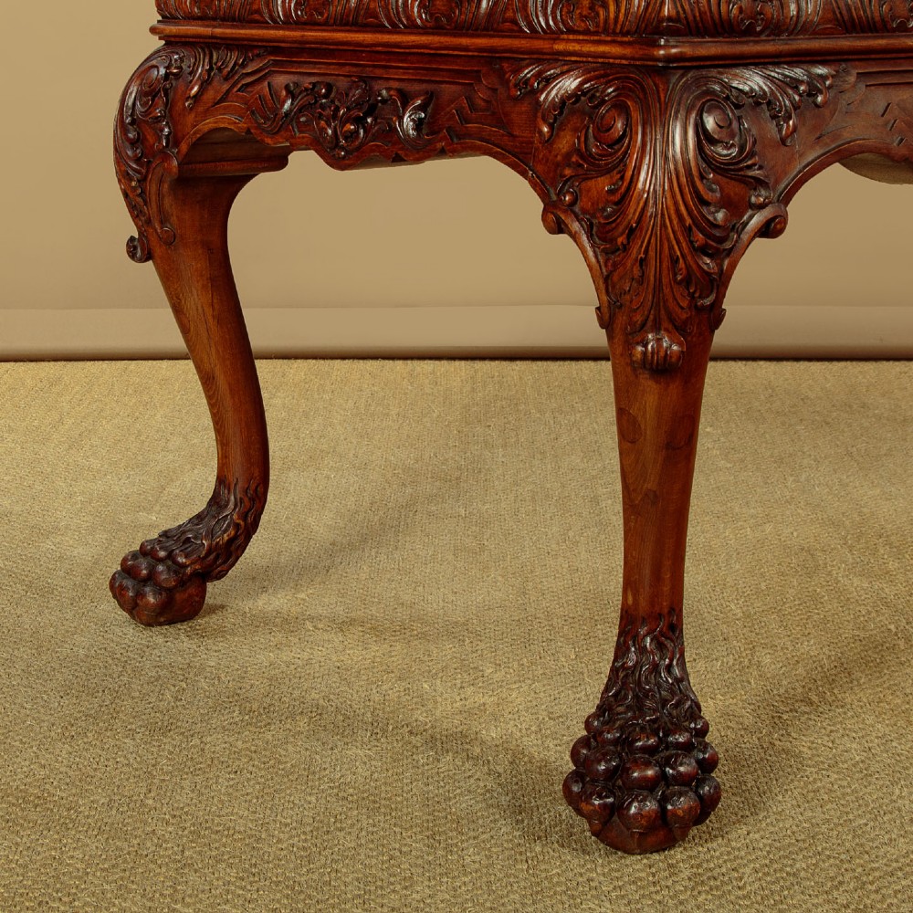 A George II style side table featuring a carved wooden frame with cabriole legs, ball and claw feet, and a polished dark marble top. View IX