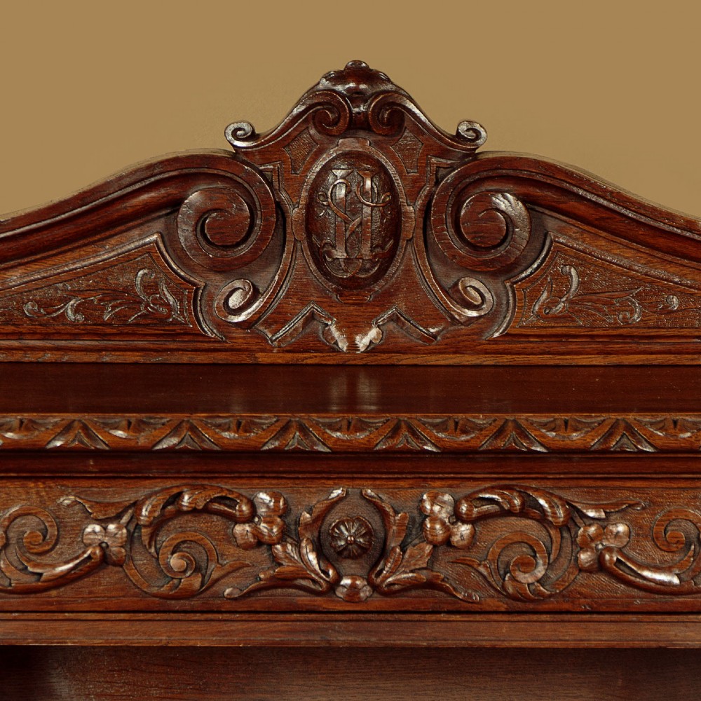 A late 19th-century dark carved oak kneehole desk featuring elaborate scrollwork carving, barley twist corner supports, and a raised superstructure with small drawers. View VII