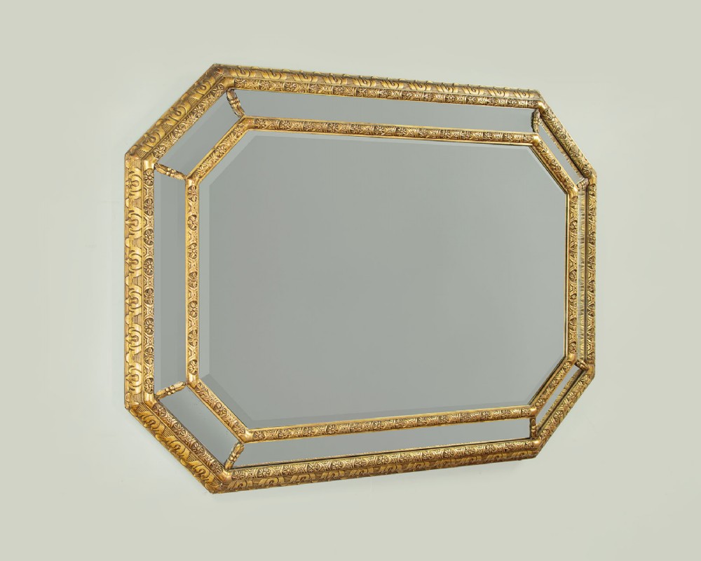 An octagonal gilded cushion frame mirror featuring floral embossed moulding and bevelled mirror inserts around a central glass plate. View III