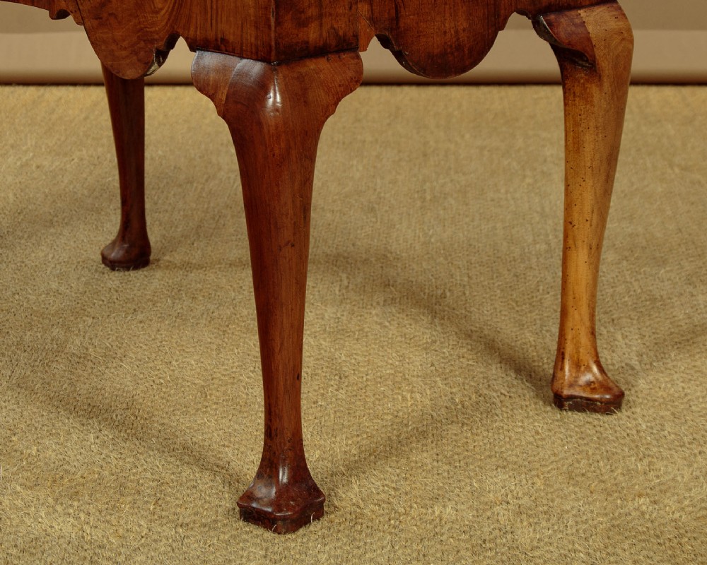A Queen Anne style walnut bureau bookcase featuring a double-domed top, glazed upper doors, a slant-front writing slope, lower drawers with a carved shell motif, and slender cabriole legs. View XIII