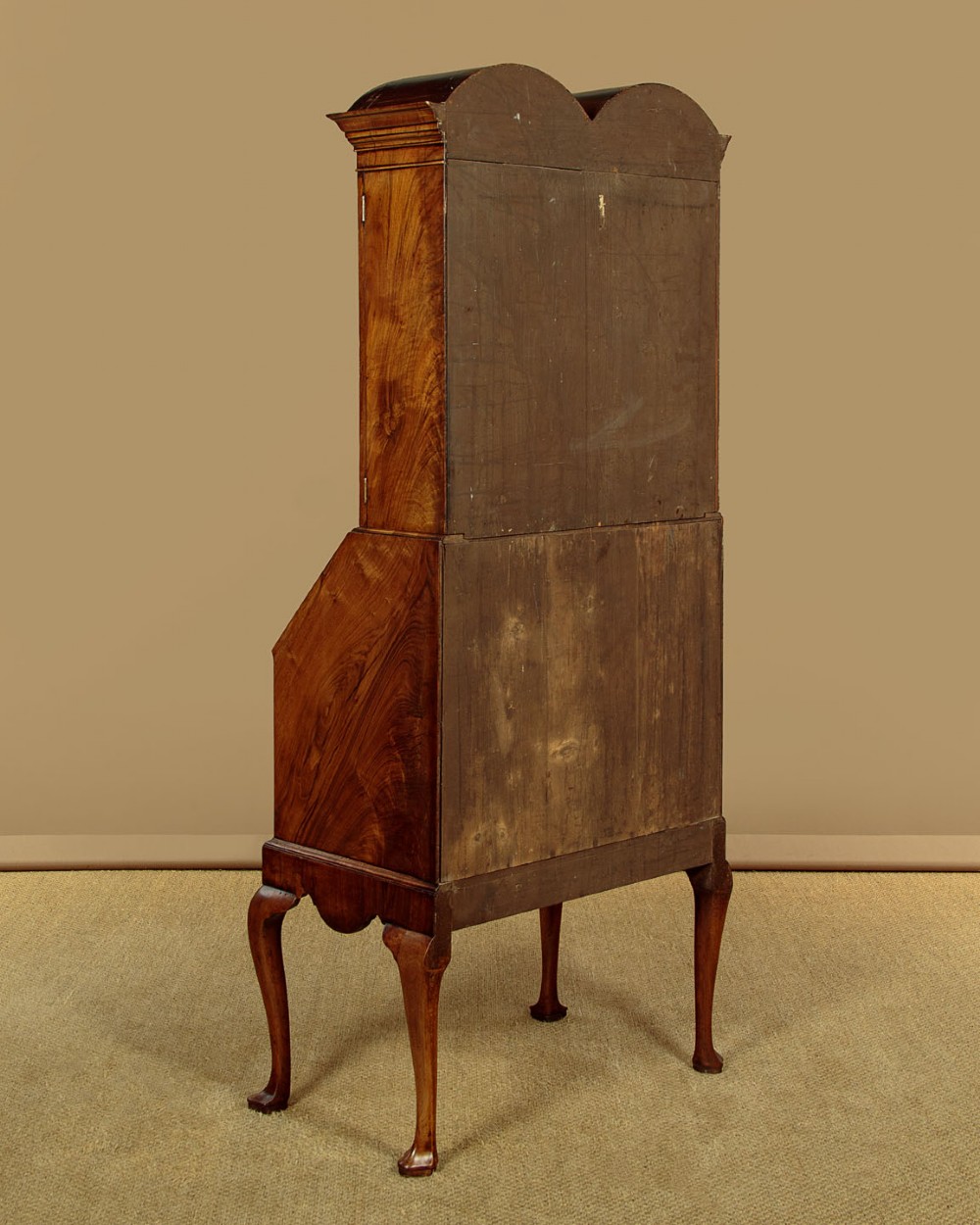A Queen Anne style walnut bureau bookcase featuring a double-domed top, glazed upper doors, a slant-front writing slope, lower drawers with a carved shell motif, and slender cabriole legs. View XV