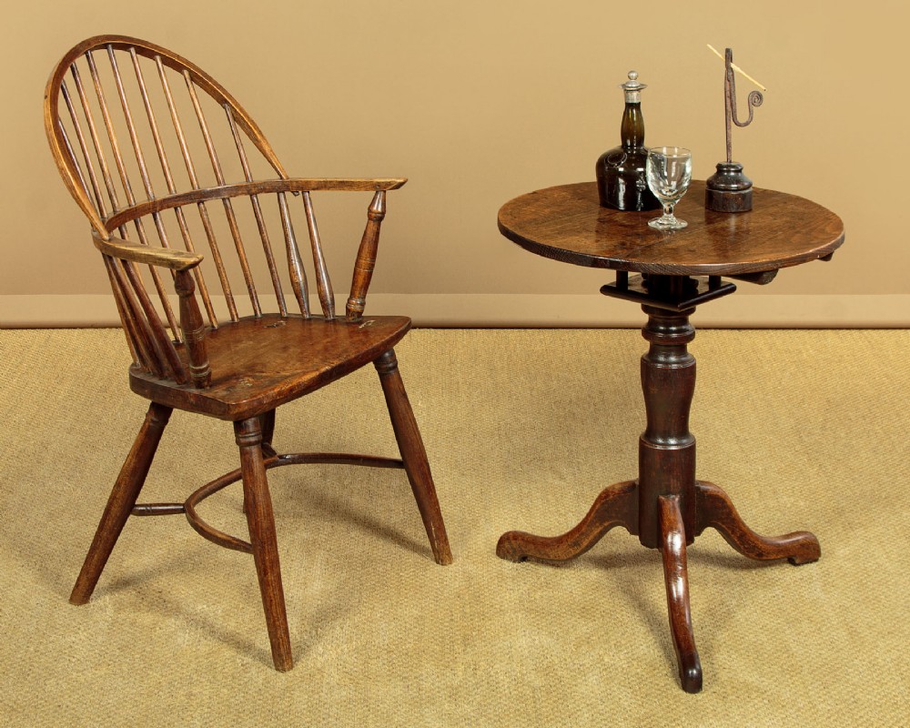 An 18th-century dark oak tripod table featuring a circular top, a central turned column, and three splayed legs. View II