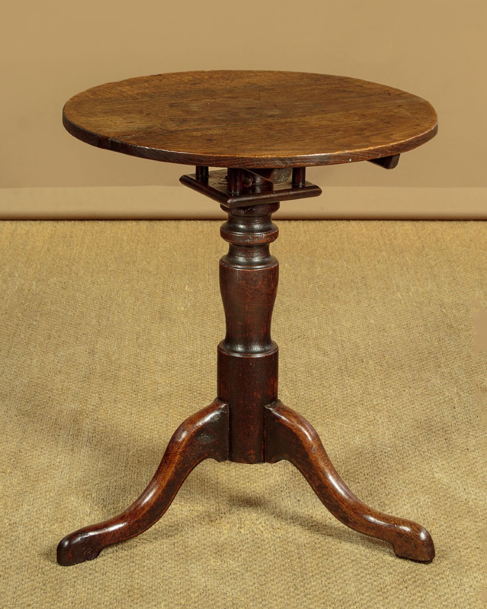 An 18th-century dark oak tripod table featuring a circular top, a central turned column, and three splayed legs. View III