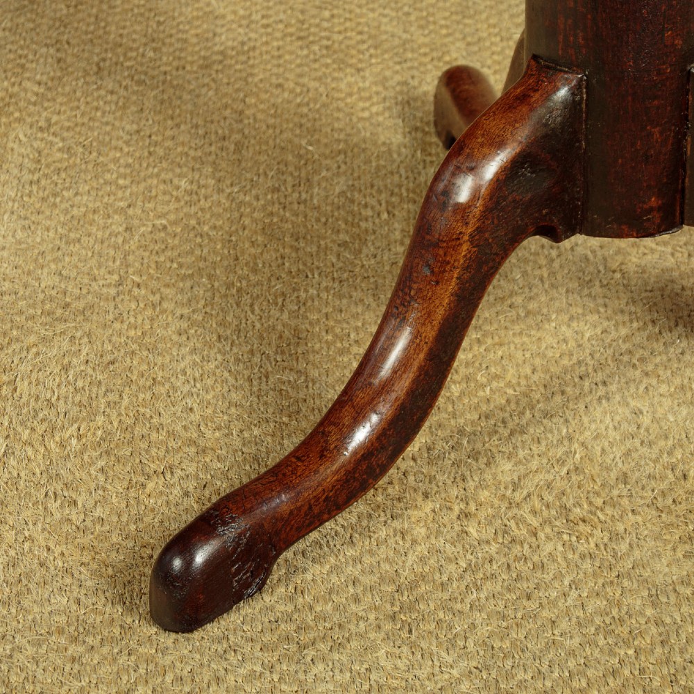 An 18th-century dark oak tripod table featuring a circular top, a central turned column, and three splayed legs. View VIII