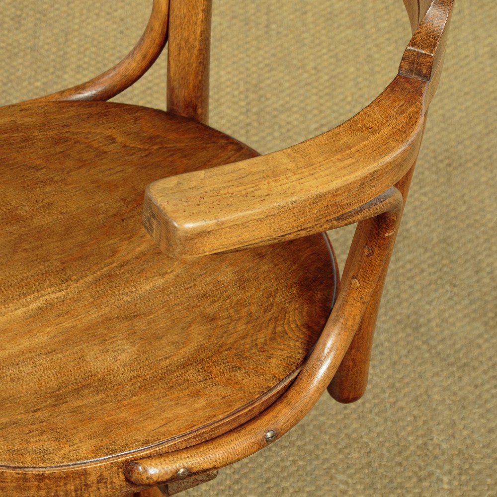 A pair of antique warm brown bentwood swivel desk chairs with curved armrests and quadruped pedestal bases. View VII