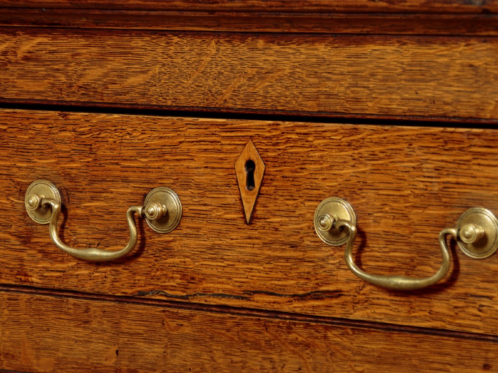 A Georgian Welsh oak cwpwrdd gwydr featuring a glazed upper section with two six-pane glass doors above three small drawers, resting on a base cabinet with two drawers over a panelled double cupboard. View VIII