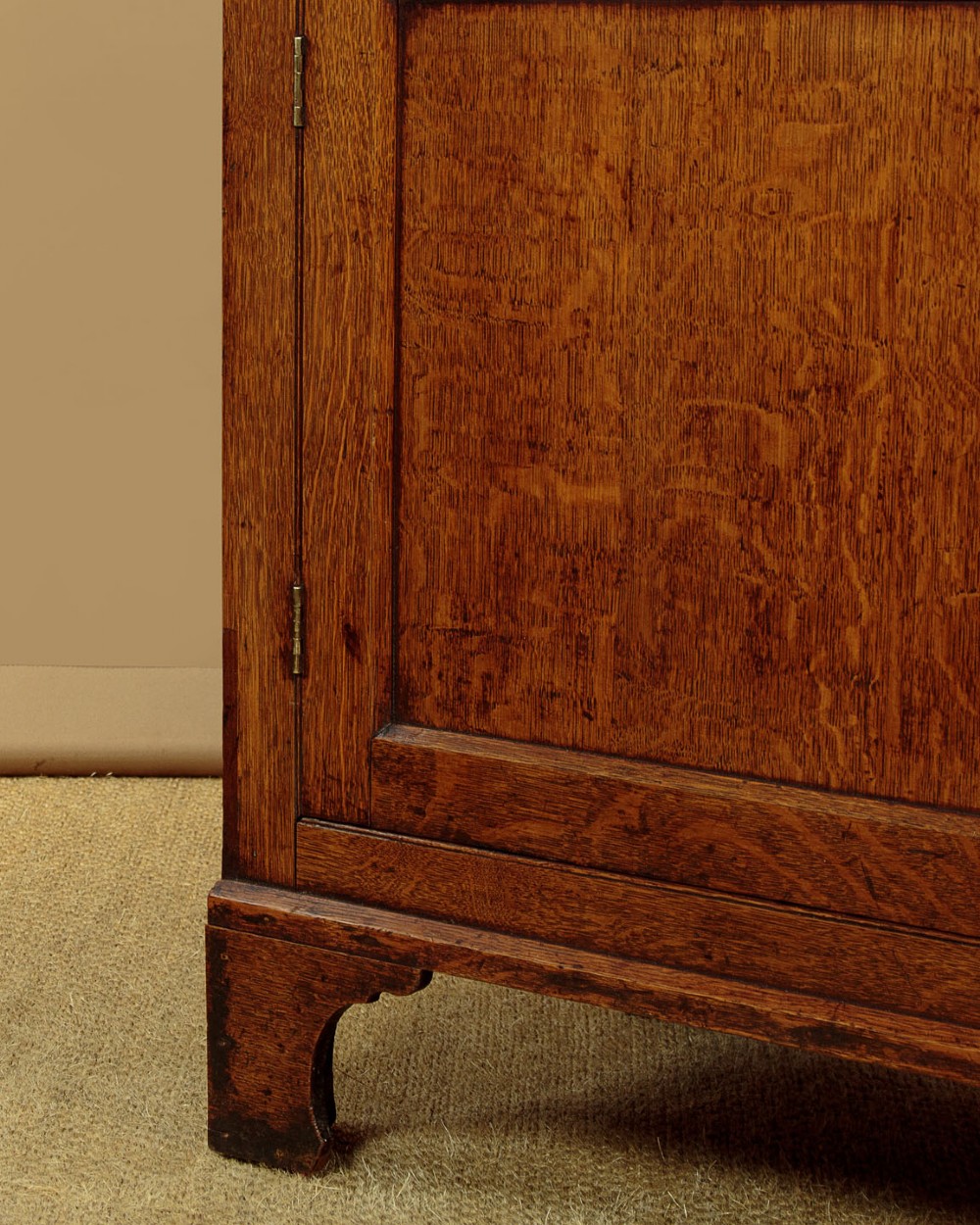 A Georgian Welsh oak cwpwrdd gwydr featuring a glazed upper section with two six-pane glass doors above three small drawers, resting on a base cabinet with two drawers over a panelled double cupboard. View XI