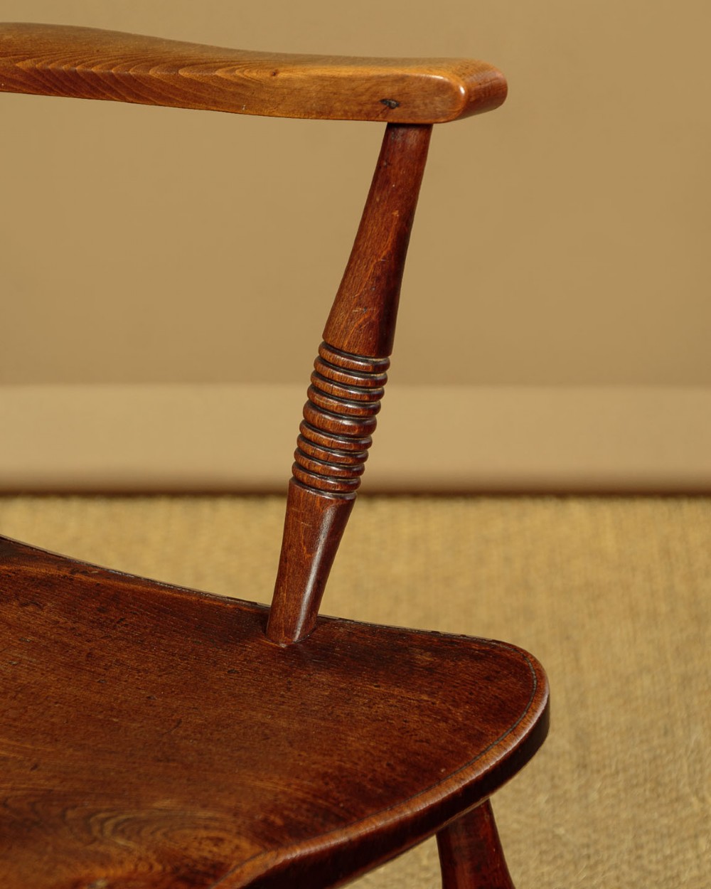 A Victorian Oxford bar back Windsor armchair made from dark timber with turned legs, a carved middle back rail, and a contoured saddle seat. View XI