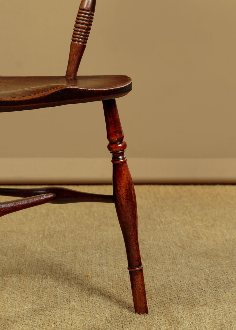 A Victorian Oxford bar back Windsor armchair made from dark timber with turned legs, a carved middle back rail, and a contoured saddle seat. View XIII
