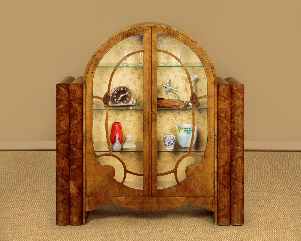 An Art Deco walnut display cabinet featuring a domed central section with two glazed doors and curved glazing bars, flanked by open side shelves. View II