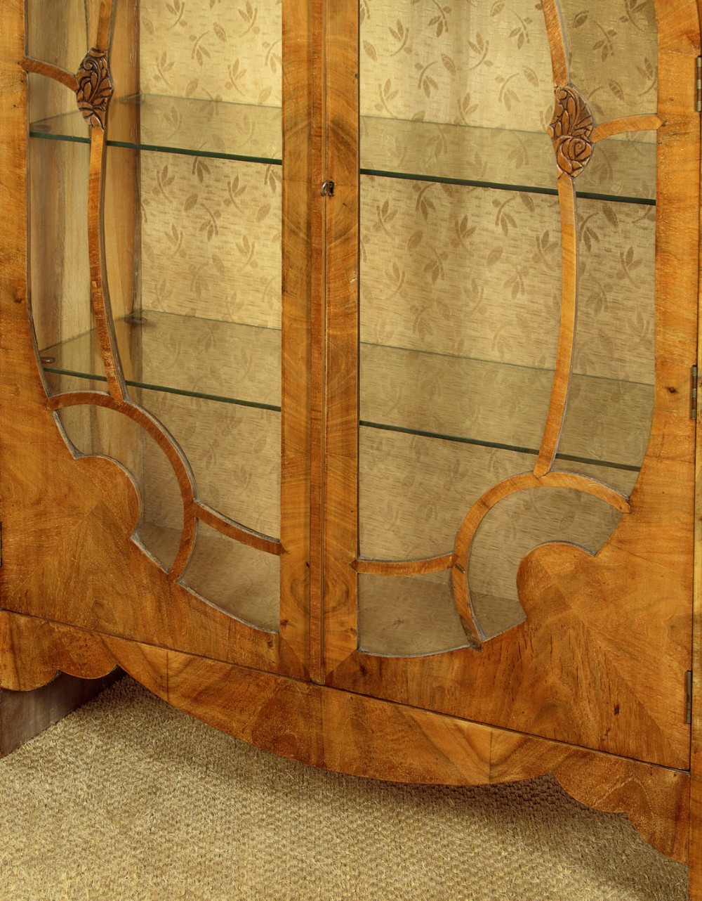 An Art Deco walnut display cabinet featuring a domed central section with two glazed doors and curved glazing bars, flanked by open side shelves. View VI