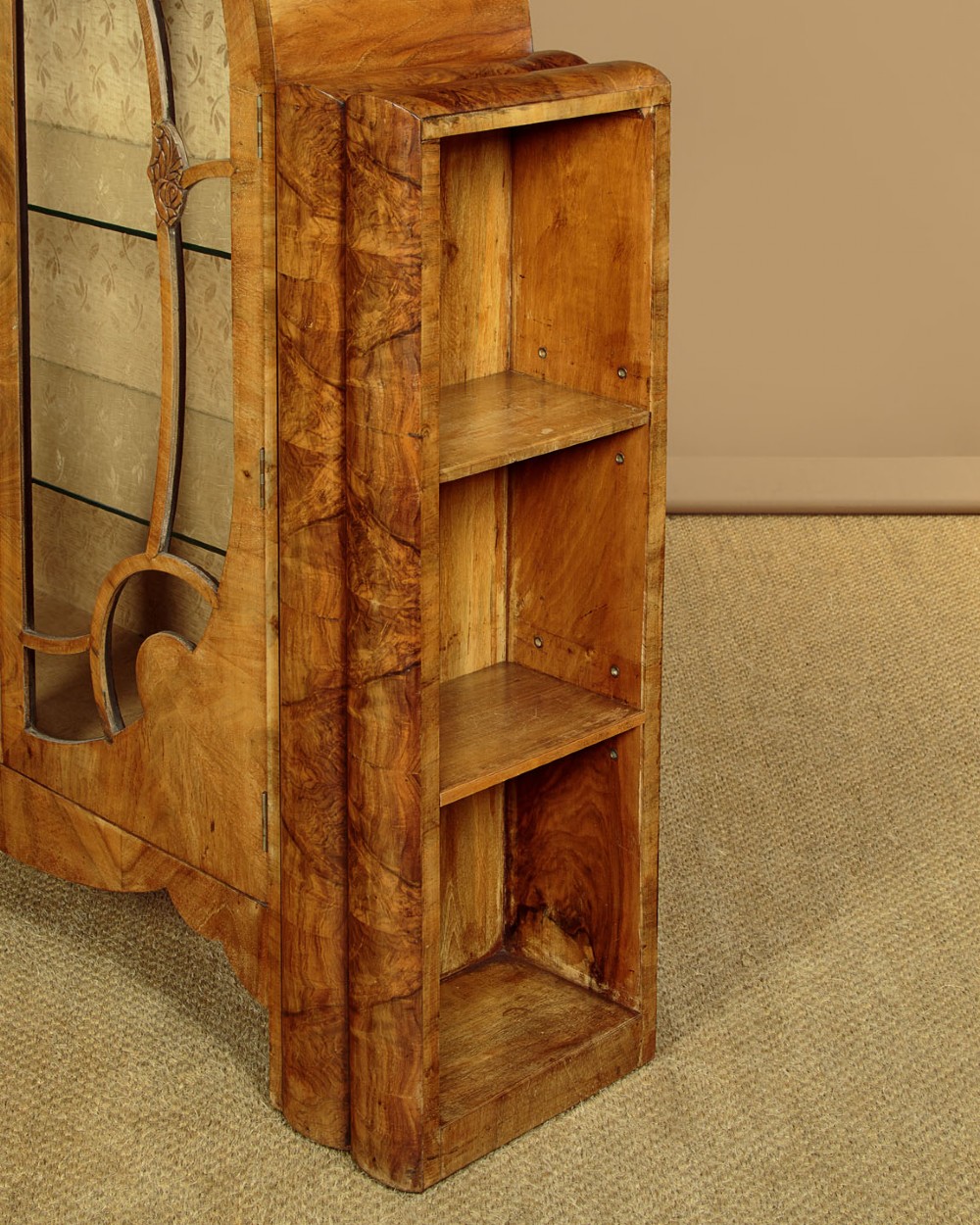 An Art Deco walnut display cabinet featuring a domed central section with two glazed doors and curved glazing bars, flanked by open side shelves. View VIII