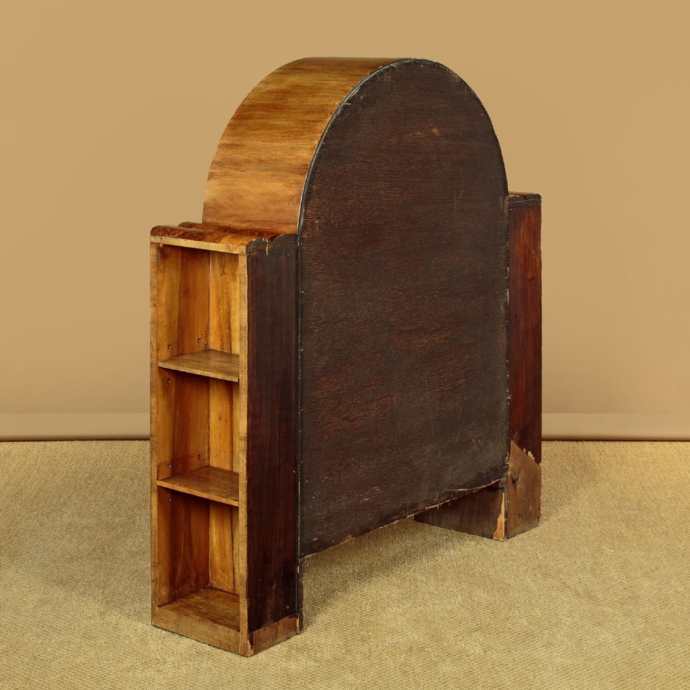 An Art Deco walnut display cabinet featuring a domed central section with two glazed doors and curved glazing bars, flanked by open side shelves. View X