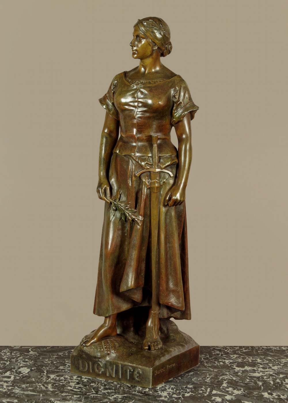 A patinated spelter statue of a standing female figure titled Dignite holding a sword and foliage branch, mounted on an integral square base.