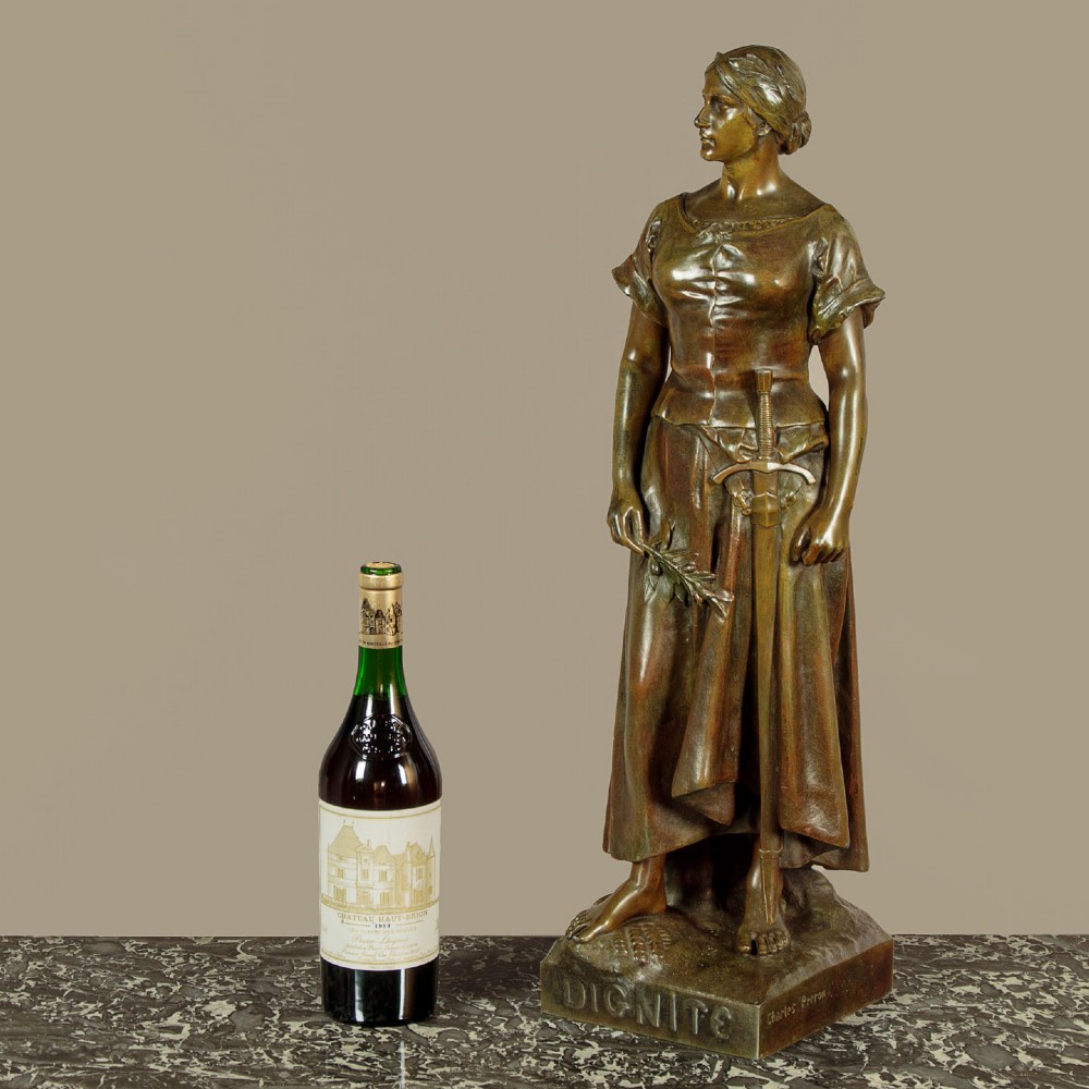 A patinated spelter statue of a standing female figure titled Dignite holding a sword and foliage branch, mounted on an integral square base. View II