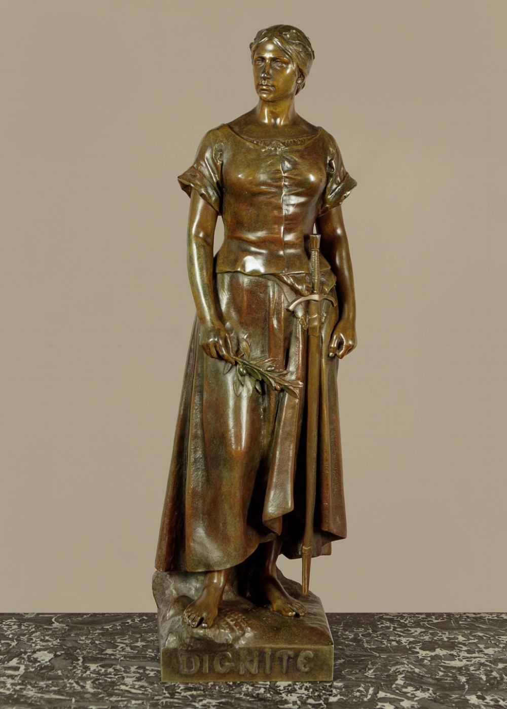 A patinated spelter statue of a standing female figure titled Dignite holding a sword and foliage branch, mounted on an integral square base. View III