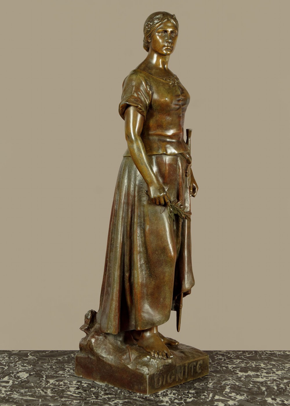 A patinated spelter statue of a standing female figure titled Dignite holding a sword and foliage branch, mounted on an integral square base. View IV