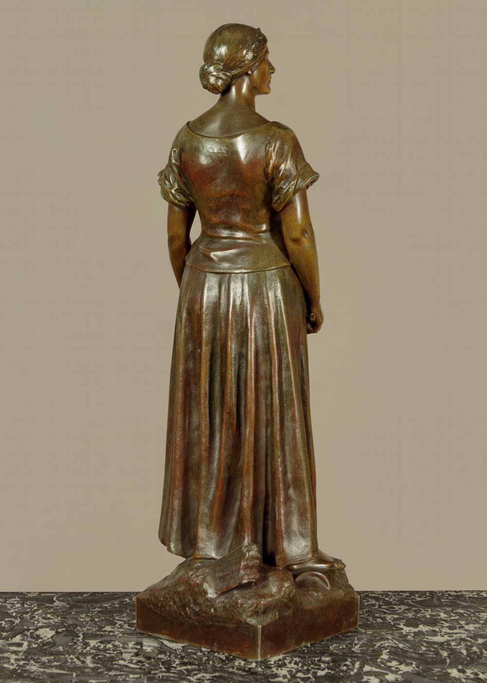 A patinated spelter statue of a standing female figure titled Dignite holding a sword and foliage branch, mounted on an integral square base. View V