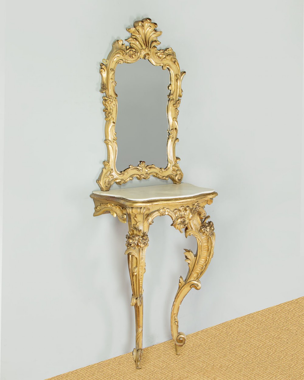 A small Rococo Revival gilded console table with a marble top, paired with an ornate matching carved wall mirror. View II