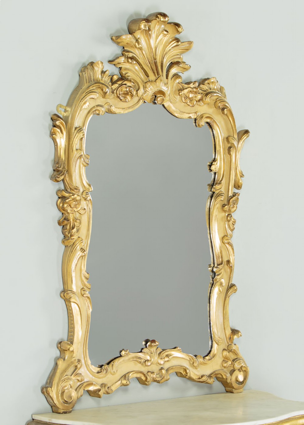 A small Rococo Revival gilded console table with a marble top, paired with an ornate matching carved wall mirror. View III