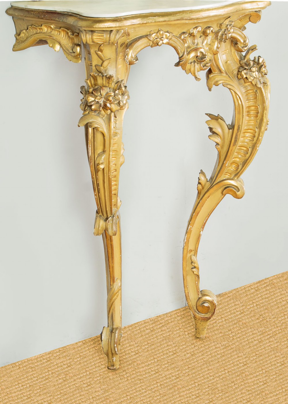 A small Rococo Revival gilded console table with a marble top, paired with an ornate matching carved wall mirror. View VIII