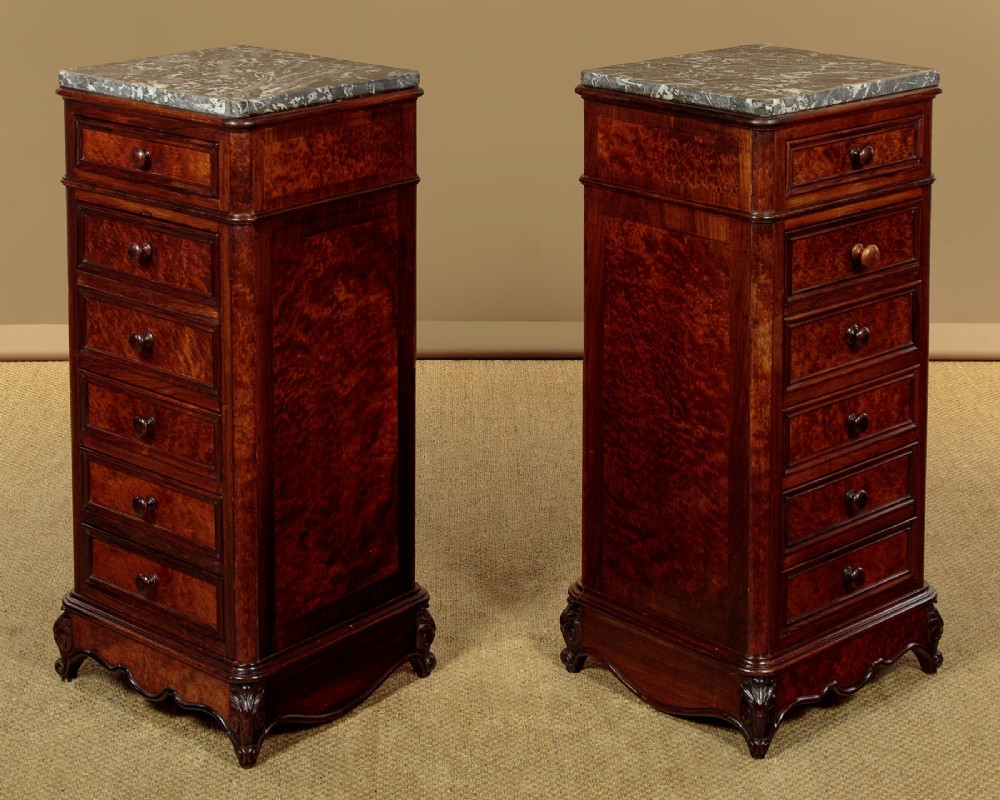A pair of late Victorian dark rosewood and amboyna veneer tall bedside drawer pedestals featuring grey marble tops and turned wooden knobs. View III