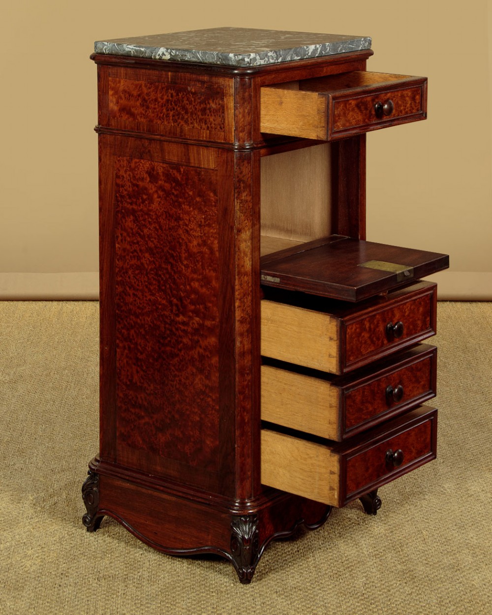 A pair of late Victorian dark rosewood and amboyna veneer tall bedside drawer pedestals featuring grey marble tops and turned wooden knobs. View VI