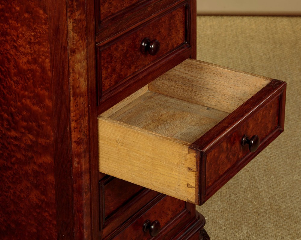 A pair of late Victorian dark rosewood and amboyna veneer tall bedside drawer pedestals featuring grey marble tops and turned wooden knobs. View VII