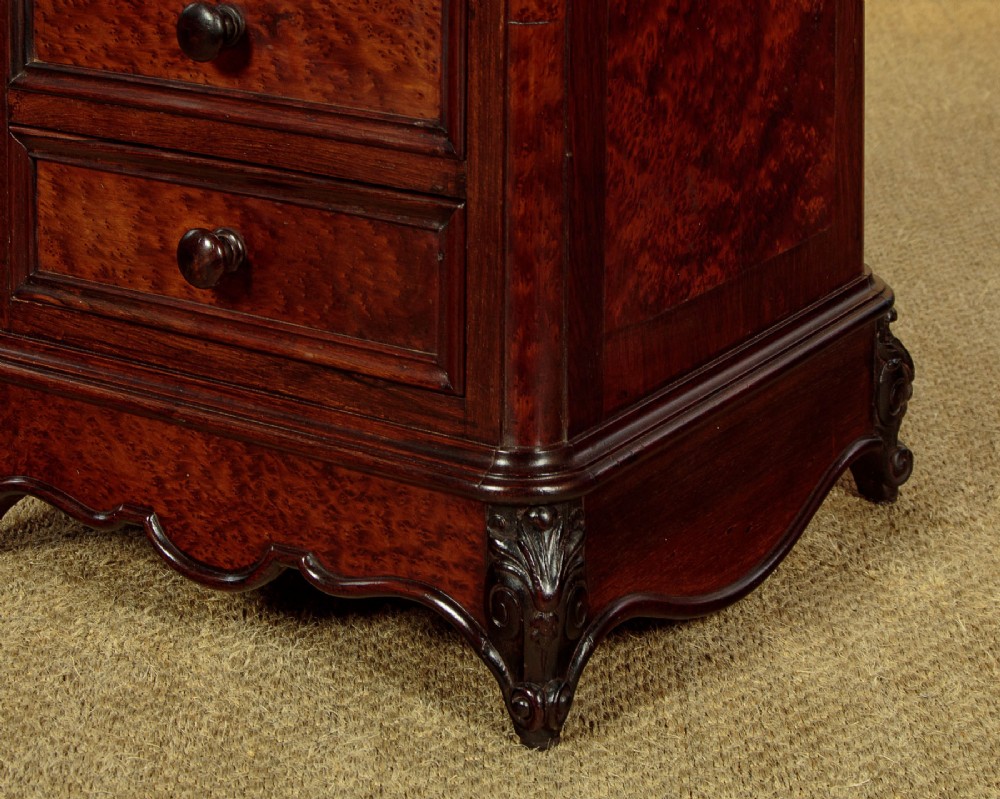 A pair of late Victorian dark rosewood and amboyna veneer tall bedside drawer pedestals featuring grey marble tops and turned wooden knobs. View IX