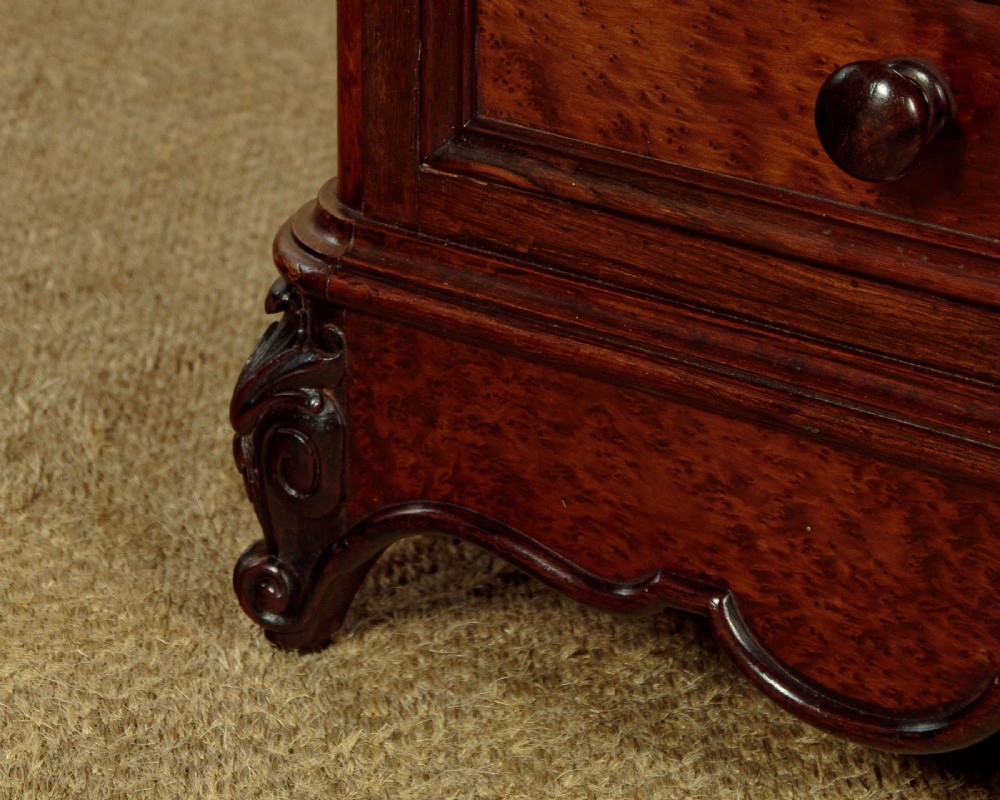 A pair of late Victorian dark rosewood and amboyna veneer tall bedside drawer pedestals featuring grey marble tops and turned wooden knobs. View X