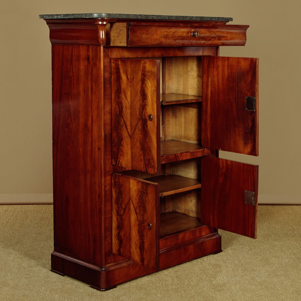 A 19th-century French Louis Philippe flame mahogany cabinet featuring a dark marble top, a frieze drawer, and four symmetrical veneered cupboard doors over a plinth base. View IV