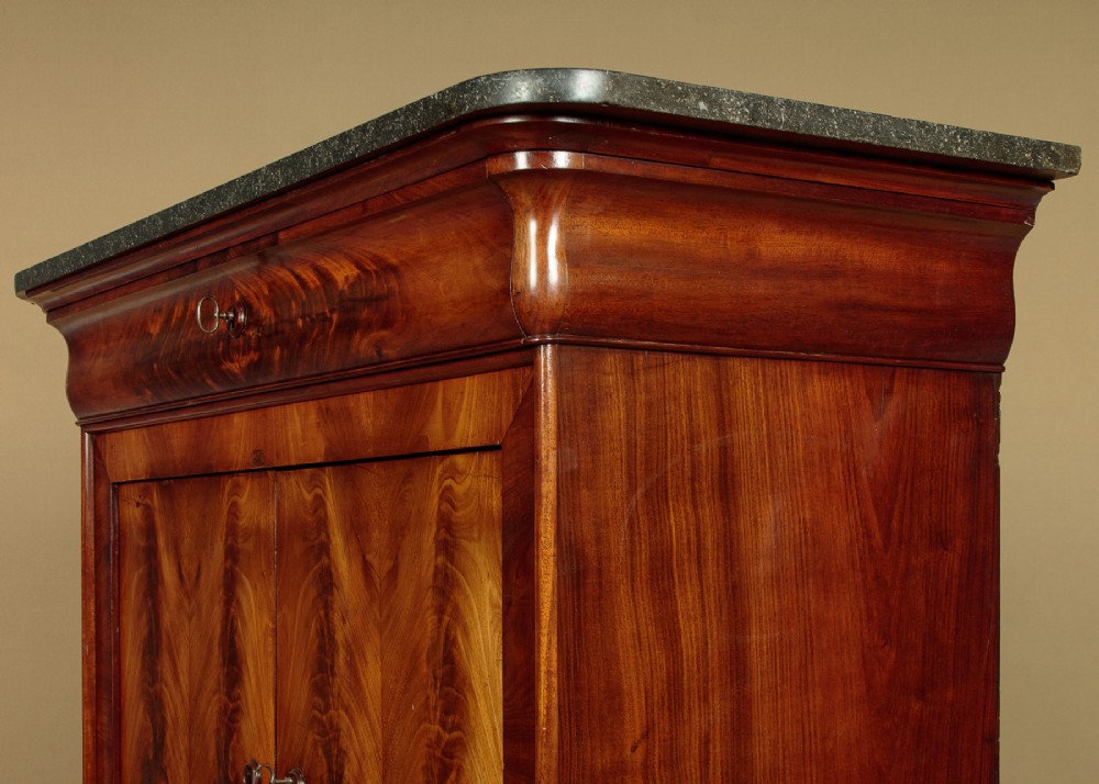 A 19th-century French Louis Philippe flame mahogany cabinet featuring a dark marble top, a frieze drawer, and four symmetrical veneered cupboard doors over a plinth base. View VIII