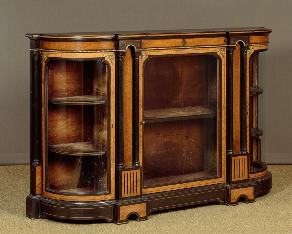 A late Victorian ebonised and burr walnut credenza featuring a central glazed door flanked by two curved side display glass doors with fluted column supports. View III