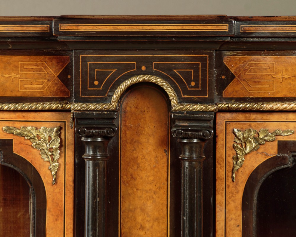 A late Victorian ebonised and burr walnut credenza featuring a central glazed door flanked by two curved side display glass doors with fluted column supports. View VIII