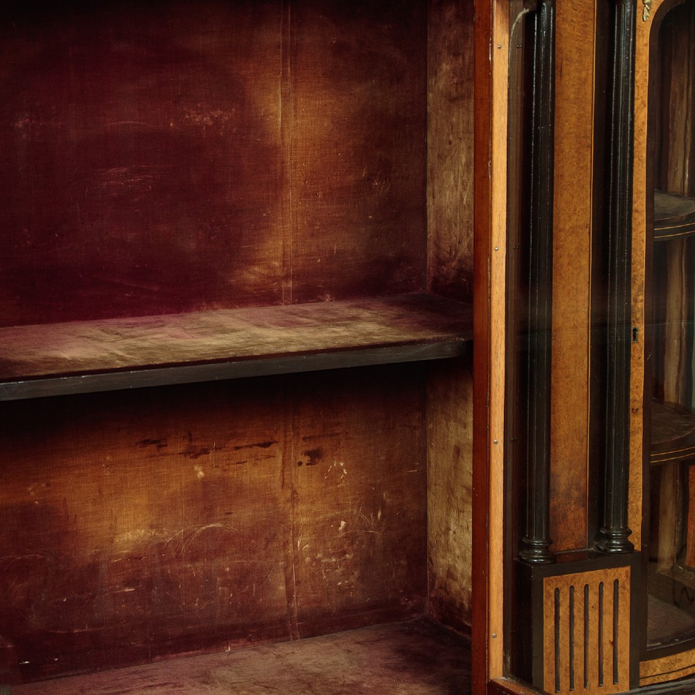 A late Victorian ebonised and burr walnut credenza featuring a central glazed door flanked by two curved side display glass doors with fluted column supports. View X