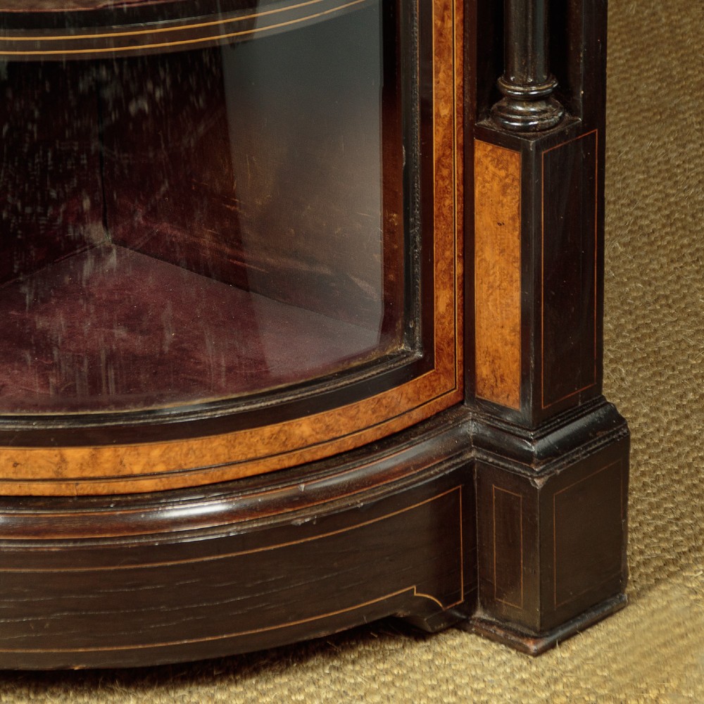 A late Victorian ebonised and burr walnut credenza featuring a central glazed door flanked by two curved side display glass doors with fluted column supports. View XII
