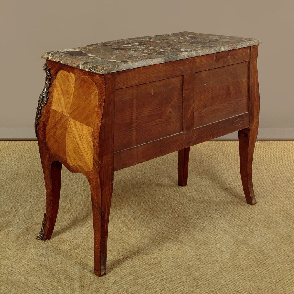 A 1930s Louis XV style bombe commode featuring a variegated grey marble top, parquetry wood veneer drawers, and ornate brass mounts. View XIII