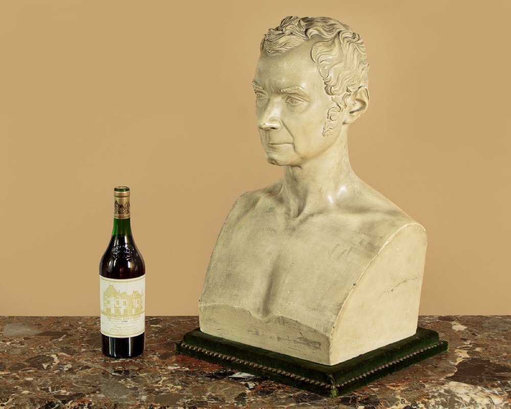 An off-white mid-nineteenth-century plaster bust depicting a gentleman with short wavy hair and bare shoulders. View II