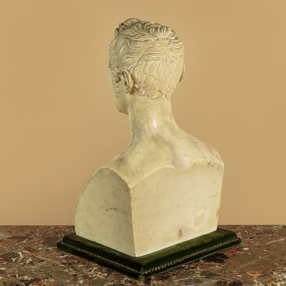 An off-white mid-nineteenth-century plaster bust depicting a gentleman with short wavy hair and bare shoulders. View X