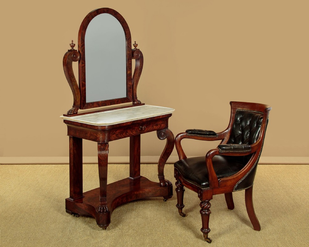 A mid-19th-century mahogany dressing table featuring a white marble surface, arched swing mirror on carved scroll supports, and lower plinth base. View II