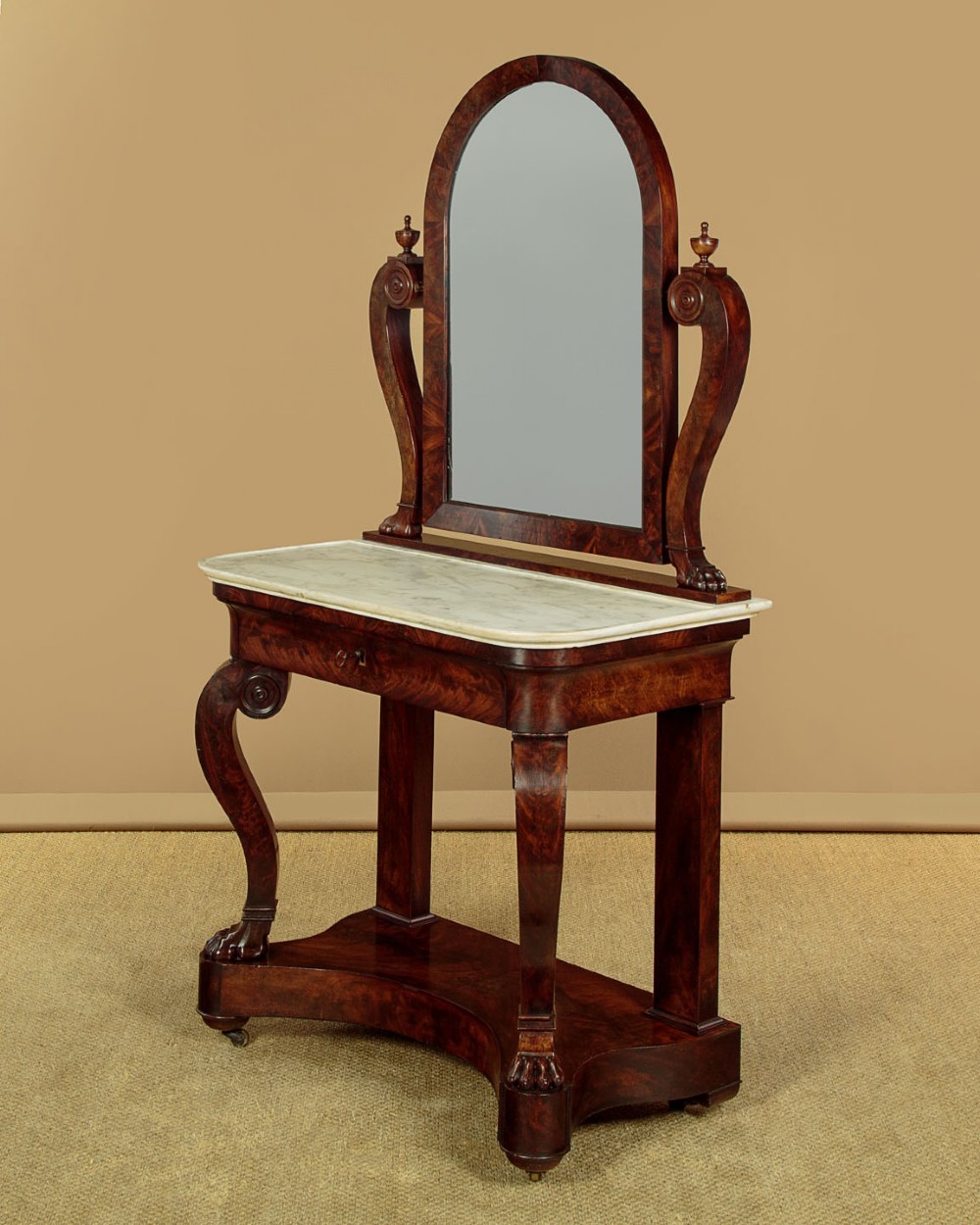 A mid-19th-century mahogany dressing table featuring a white marble surface, arched swing mirror on carved scroll supports, and lower plinth base. View IV