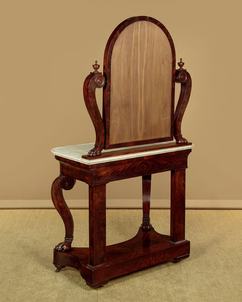 A mid-19th-century mahogany dressing table featuring a white marble surface, arched swing mirror on carved scroll supports, and lower plinth base. View XIV