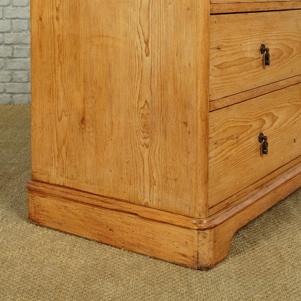 A late Victorian natural pine chest of drawers featuring a two short over two long drawer layout with brass drop handles. View IX