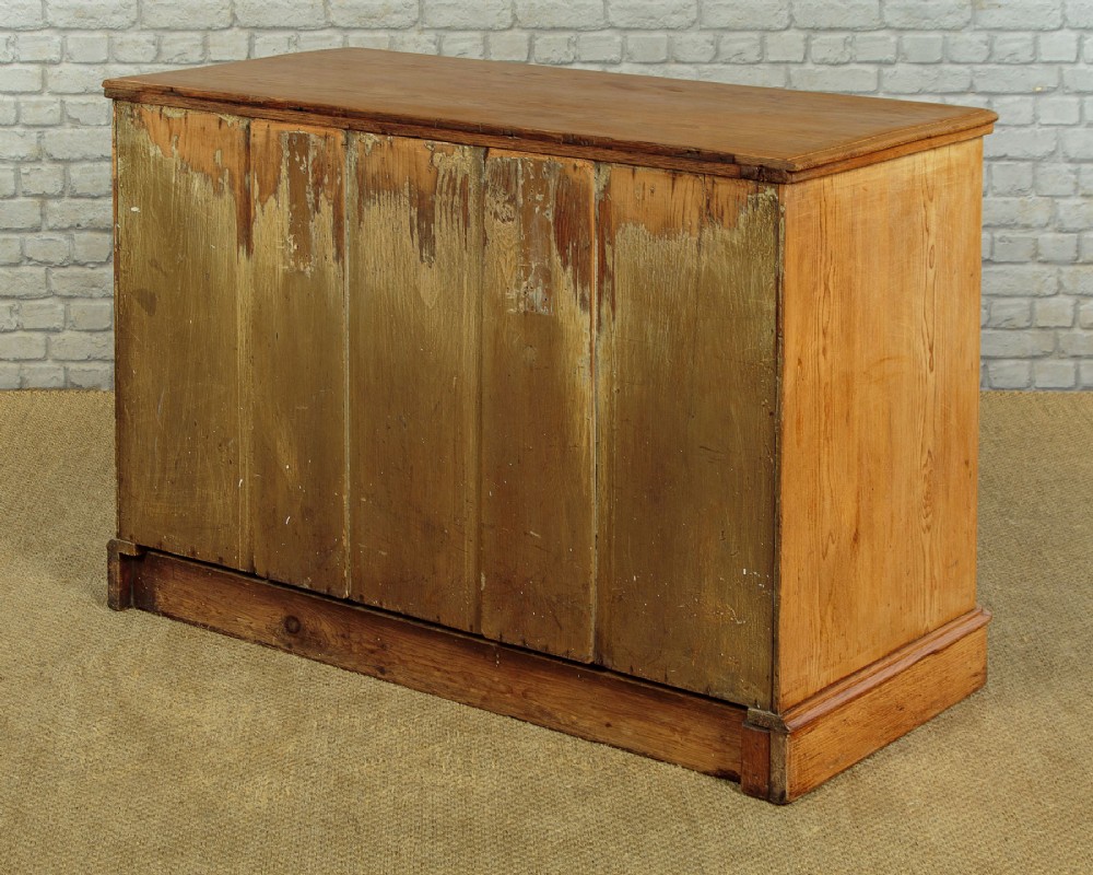 A late Victorian natural pine chest of drawers featuring a two short over two long drawer layout with brass drop handles. View X