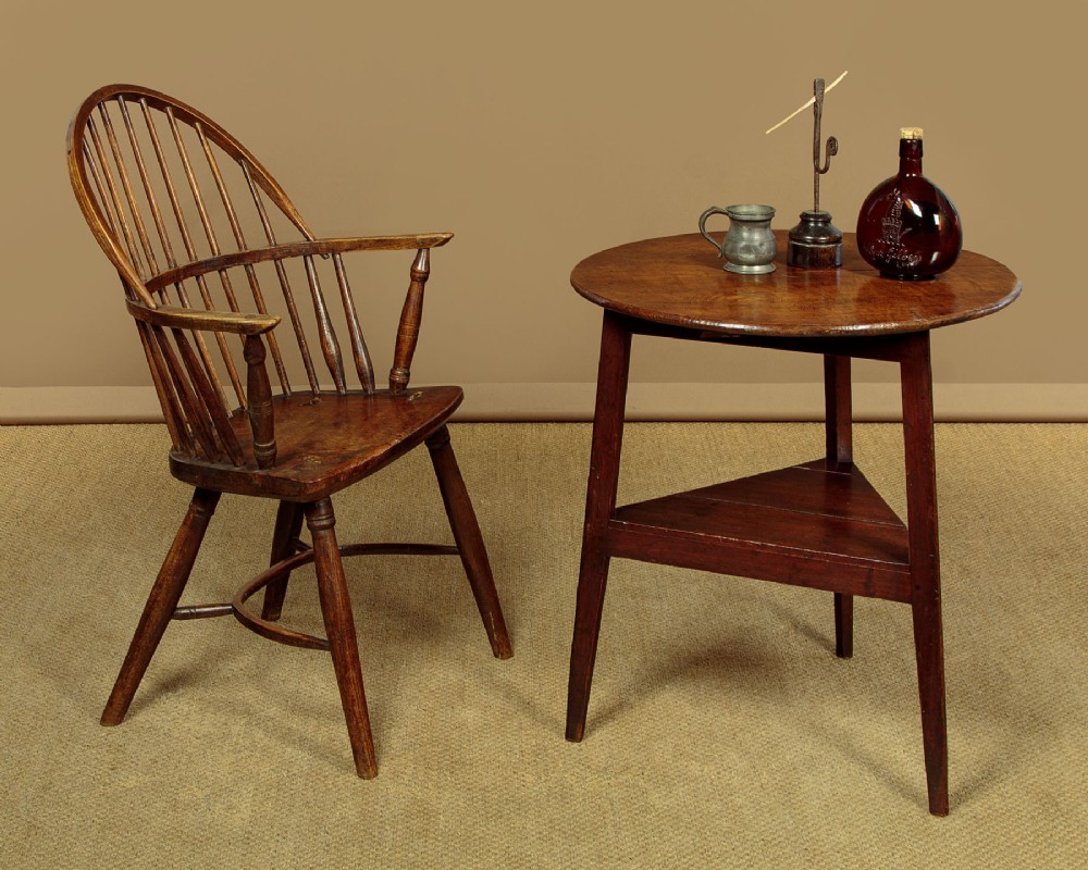 A mid-19th-century pollard oak cricket table with a round top, three splayed legs, and a triangular lower shelf. View II