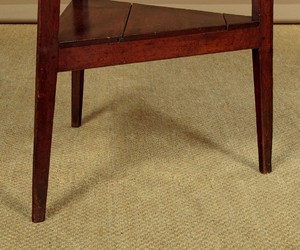 A mid-19th-century pollard oak cricket table with a round top, three splayed legs, and a triangular lower shelf. View VII
